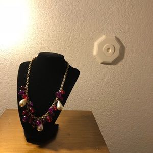 Gold colored necklace with ruby and pearl beads